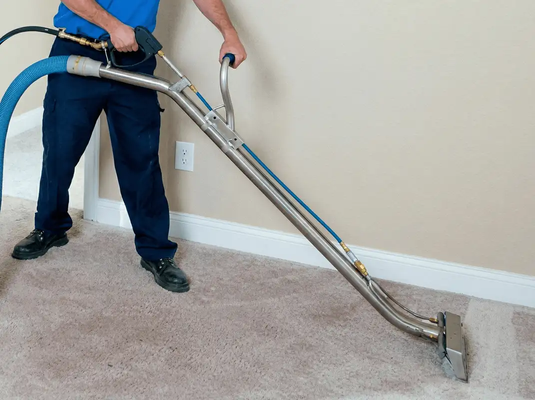Professional operating a liquid removal machine on a carpeted floor in Marietta, GA